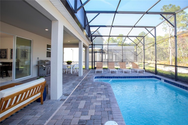 view of pool featuring grilling area, a lanai, and a patio