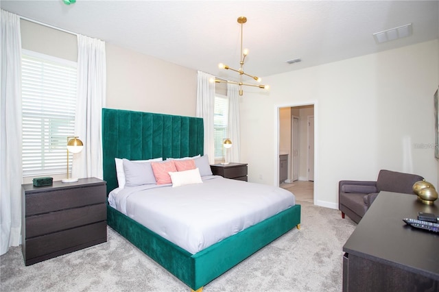 carpeted bedroom featuring multiple windows and an inviting chandelier