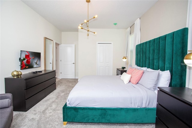 carpeted bedroom featuring a closet and an inviting chandelier