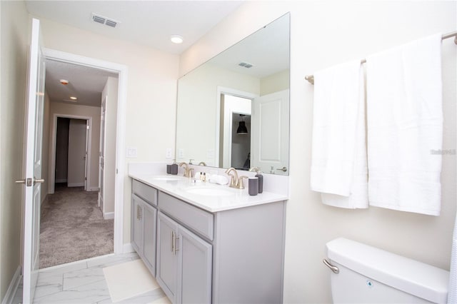 bathroom with tile flooring, toilet, and vanity