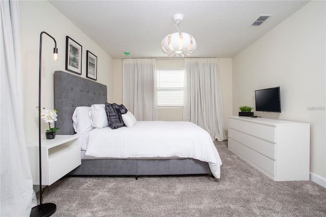 carpeted bedroom featuring a textured ceiling