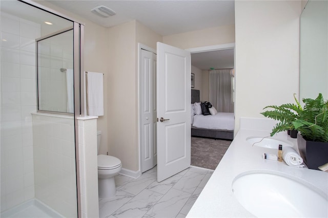 bathroom with tile floors, dual sinks, a shower with shower door, and toilet