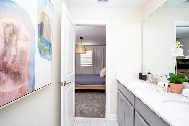 bathroom featuring tile floors, dual bowl vanity, and a textured ceiling