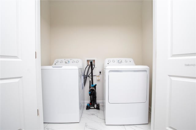 laundry area with hookup for a washing machine, washer and clothes dryer, and light tile flooring