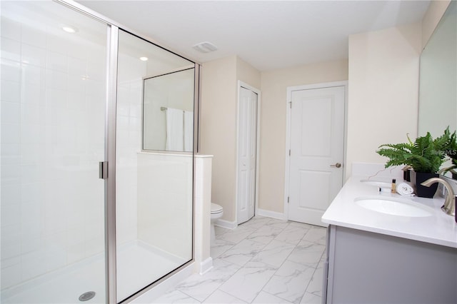 bathroom featuring tile flooring, a shower with shower door, toilet, and vanity