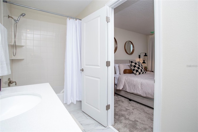 bathroom featuring tile floors, a textured ceiling, shower / tub combo, and vanity