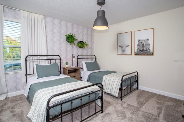 carpeted bedroom featuring a textured ceiling