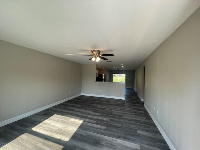 unfurnished room featuring ceiling fan and dark hardwood / wood-style floors