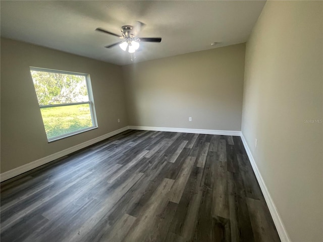 empty room featuring ceiling fan and dark hardwood / wood-style flooring