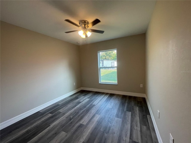 spare room featuring ceiling fan and dark wood-type flooring