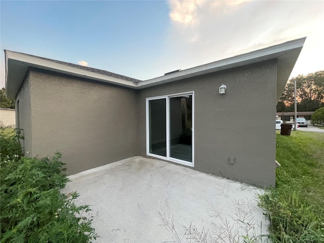 back of house featuring a patio and a lawn