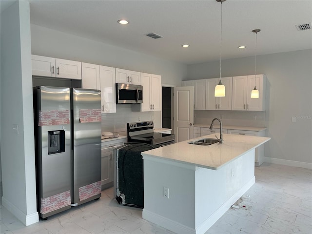 kitchen featuring decorative light fixtures, white cabinets, backsplash, stainless steel appliances, and sink