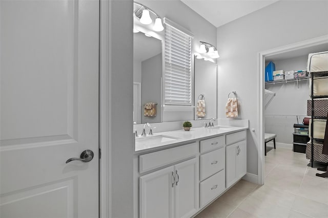 bathroom with tile floors, double sink, and large vanity