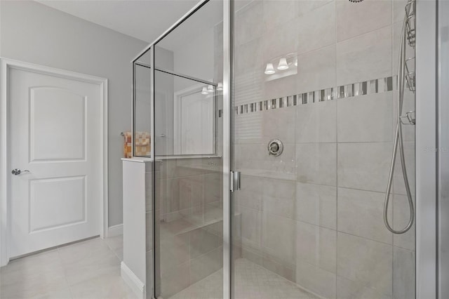 bathroom with a shower with shower door and tile flooring