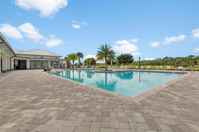 view of swimming pool featuring a patio area