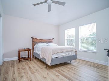 bedroom featuring light hardwood / wood-style flooring and ceiling fan