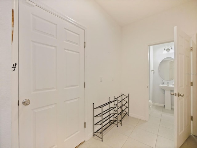 hall featuring light tile floors