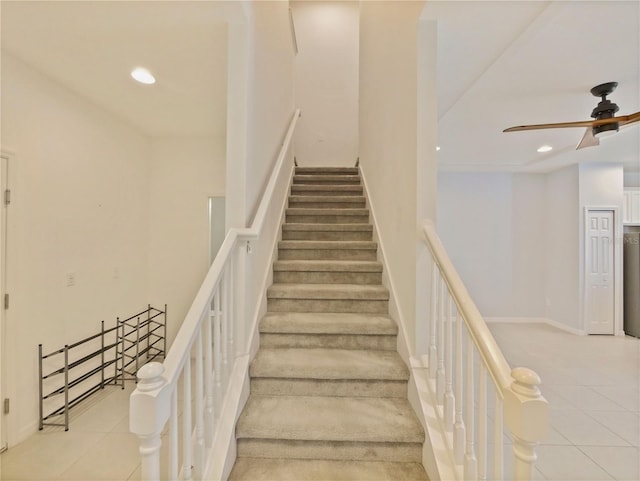 stairs with ceiling fan and light tile floors