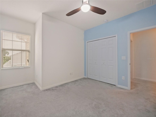 unfurnished bedroom featuring a closet, ceiling fan, and carpet floors