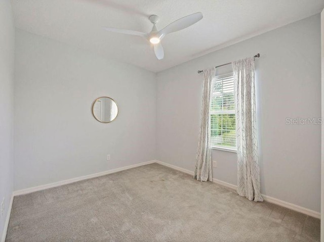 empty room with carpet floors and ceiling fan