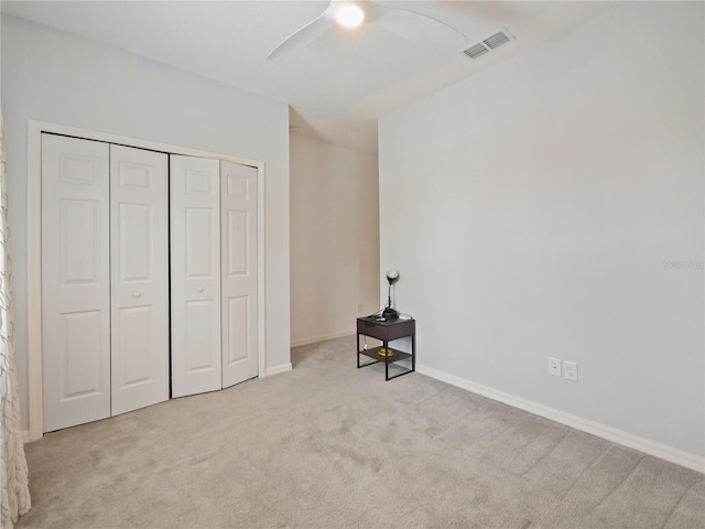 carpeted bedroom with a closet and ceiling fan