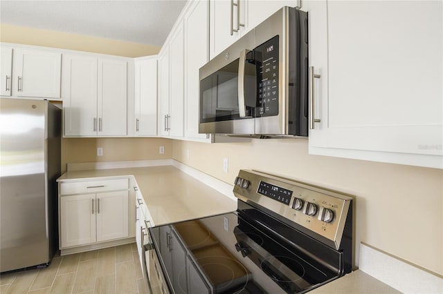 kitchen featuring white cabinetry and appliances with stainless steel finishes