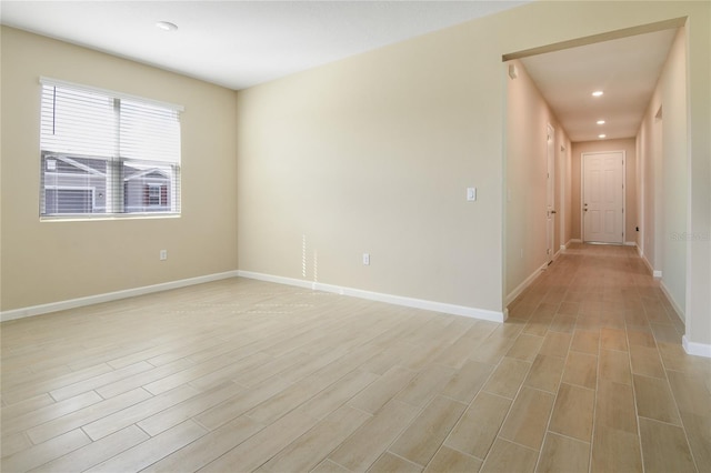 unfurnished room with light wood-type flooring