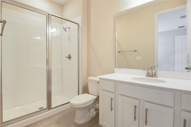 bathroom featuring vanity, toilet, and a shower with door