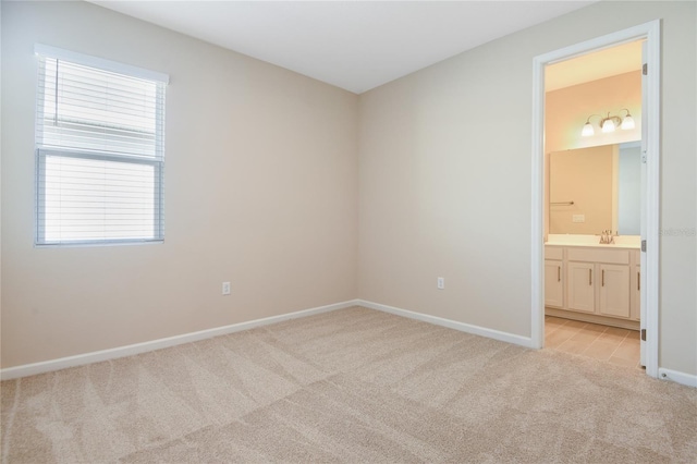 carpeted spare room with sink