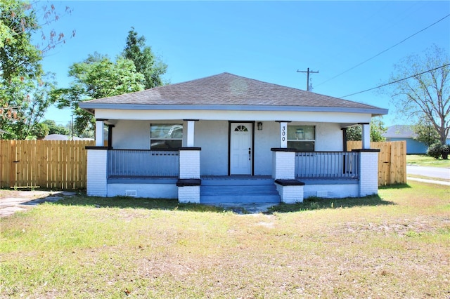 bungalow with a front yard and a porch