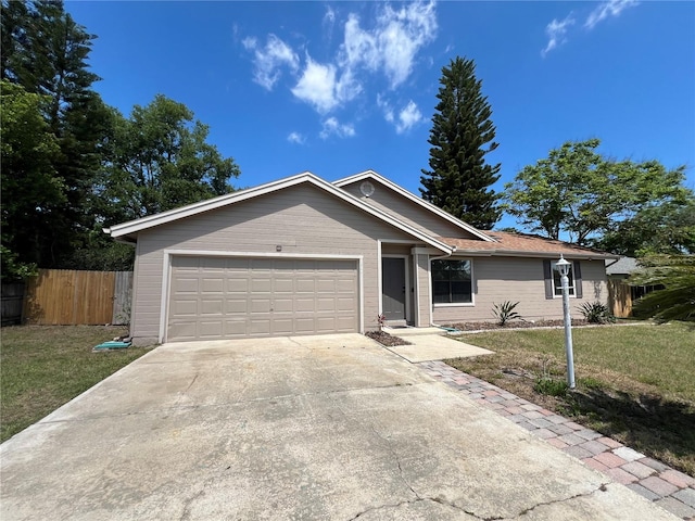 single story home with a garage and a front lawn