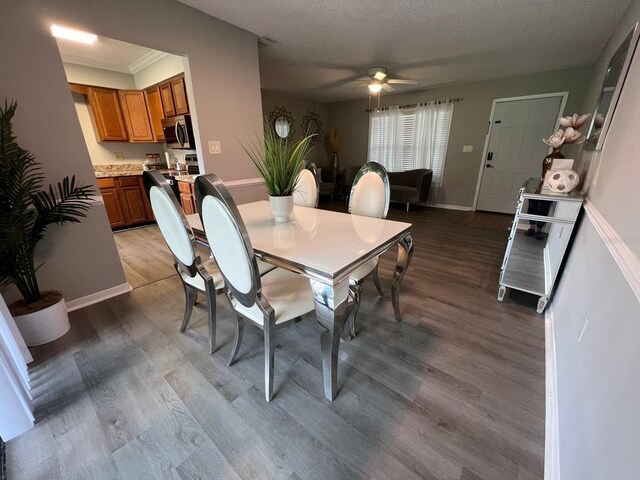 dining room featuring ceiling fan, a textured ceiling, and hardwood / wood-style floors