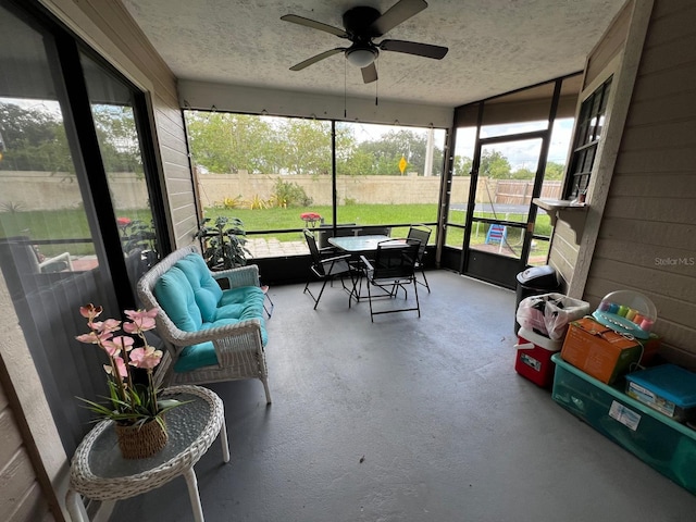 sunroom / solarium featuring ceiling fan and a wealth of natural light