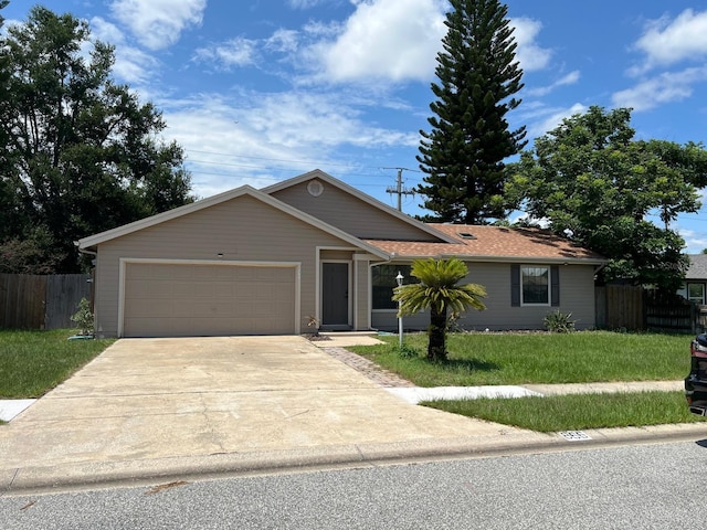 ranch-style house featuring driveway, a front lawn, an attached garage, and fence