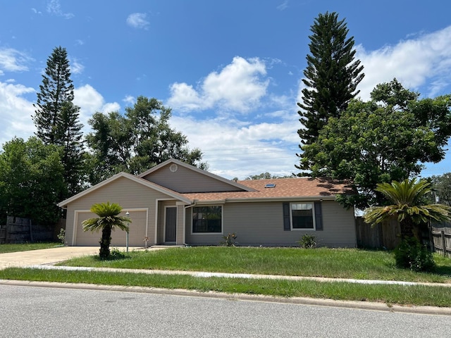 single story home with a garage and a front lawn