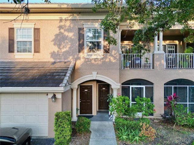 view of front of home with a garage and a balcony