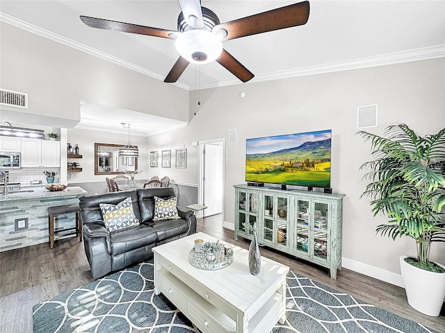 living room featuring ceiling fan, dark wood-type flooring, and ornamental molding