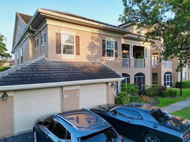 view of front of house with a garage and a balcony