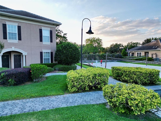 exterior space featuring volleyball court and a yard