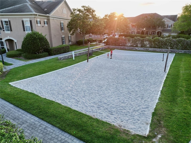 view of property's community featuring volleyball court and a lawn