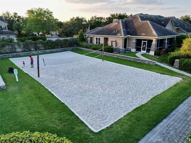 view of home's community featuring volleyball court and a yard