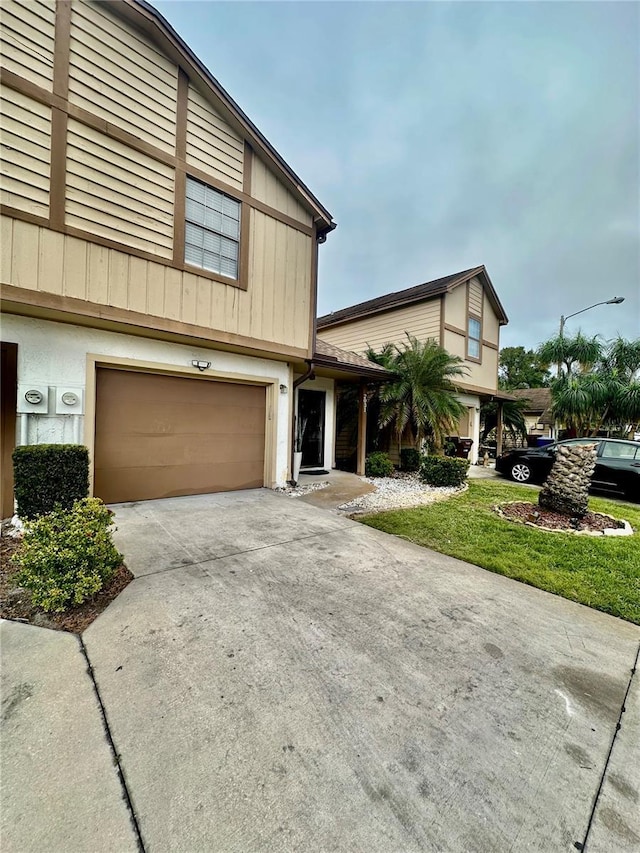 view of front of house with a garage and a front lawn