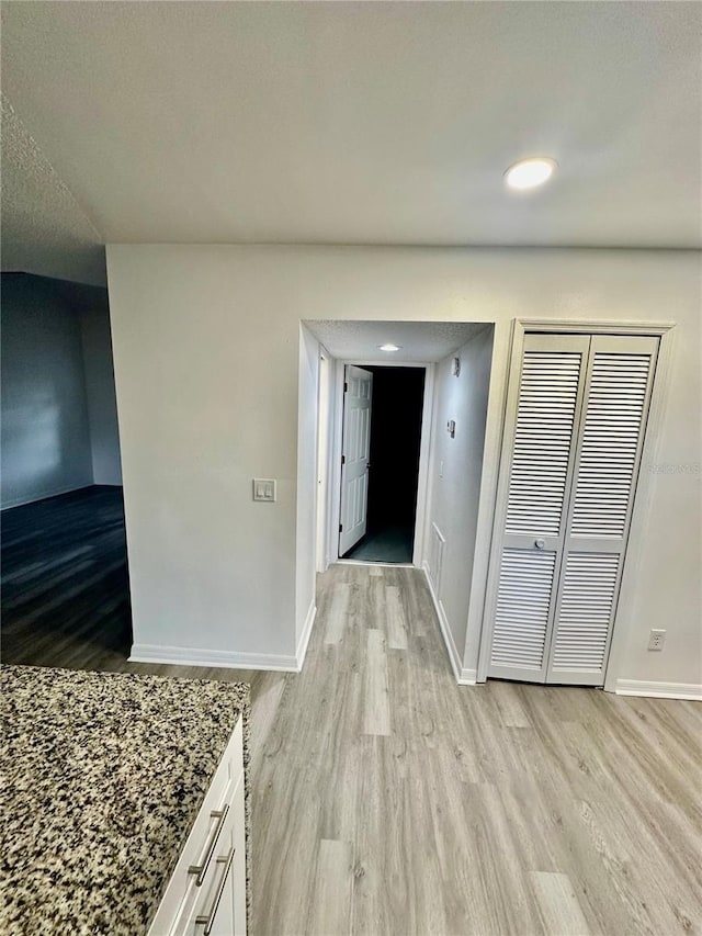 corridor featuring light hardwood / wood-style flooring