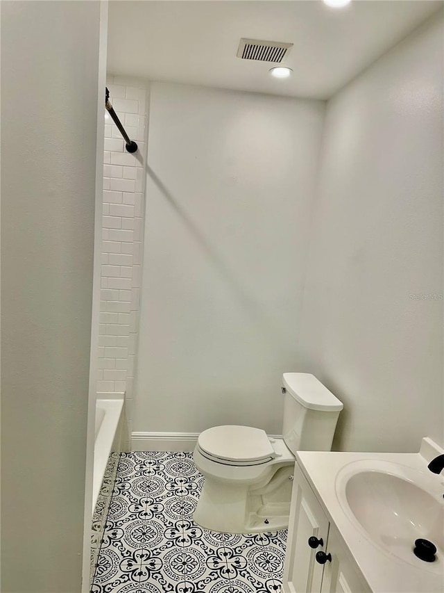 bathroom with tile patterned flooring, vanity, and toilet