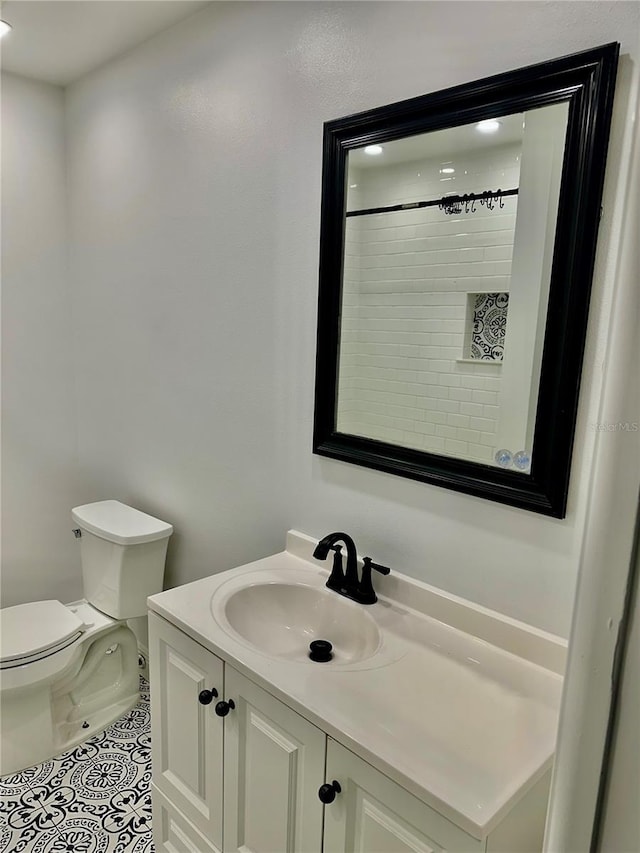 bathroom with tile patterned floors, vanity, and toilet