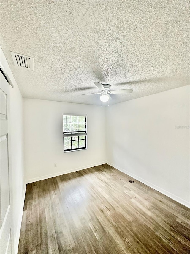 unfurnished room with ceiling fan and wood-type flooring