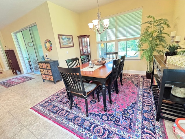 dining room featuring a notable chandelier and tile flooring