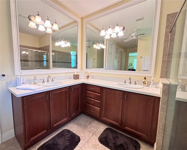 bathroom with ceiling fan with notable chandelier, double sink, tile floors, and large vanity