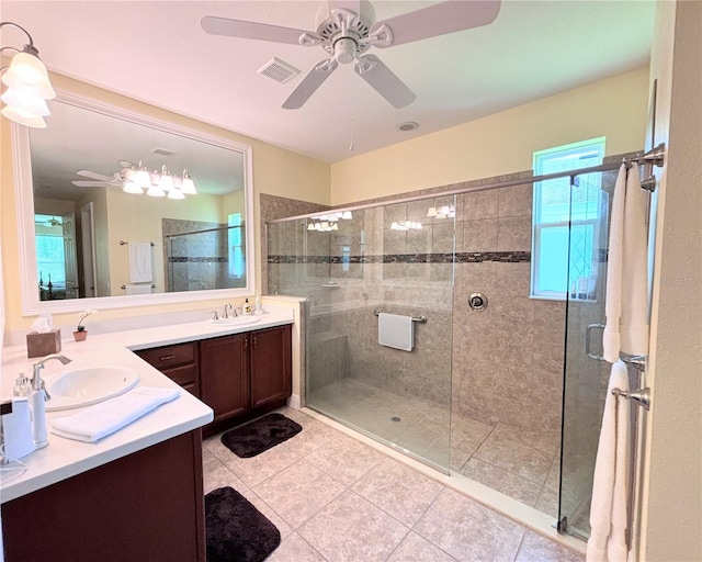 bathroom featuring ceiling fan, a shower with shower door, double sink vanity, and tile flooring