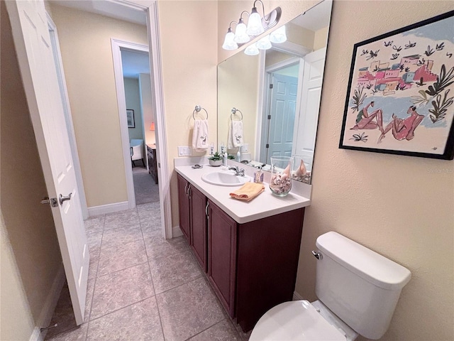 bathroom featuring tile floors, toilet, and oversized vanity